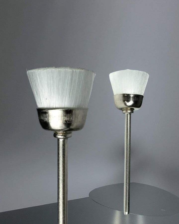 Two small soft nylon brushes with white bristles on metallic bases. These Brush E-File Bit, designed to replace traditional nail brushes for a faster, more efficient cleaning process. 