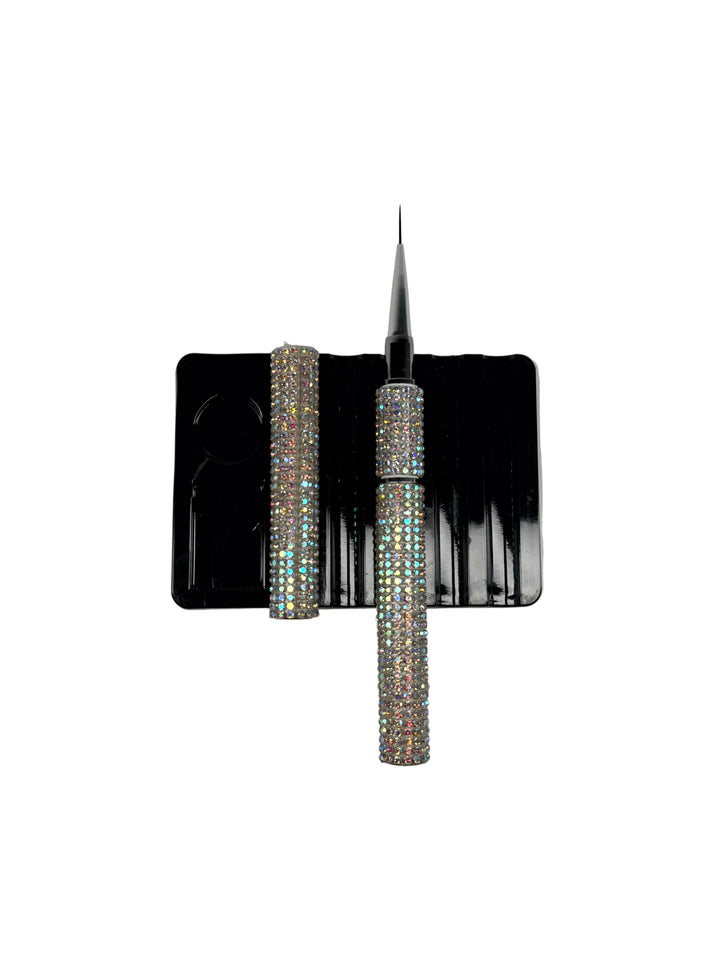 Builder gel liner brush with crystal handle on a black card against a white background