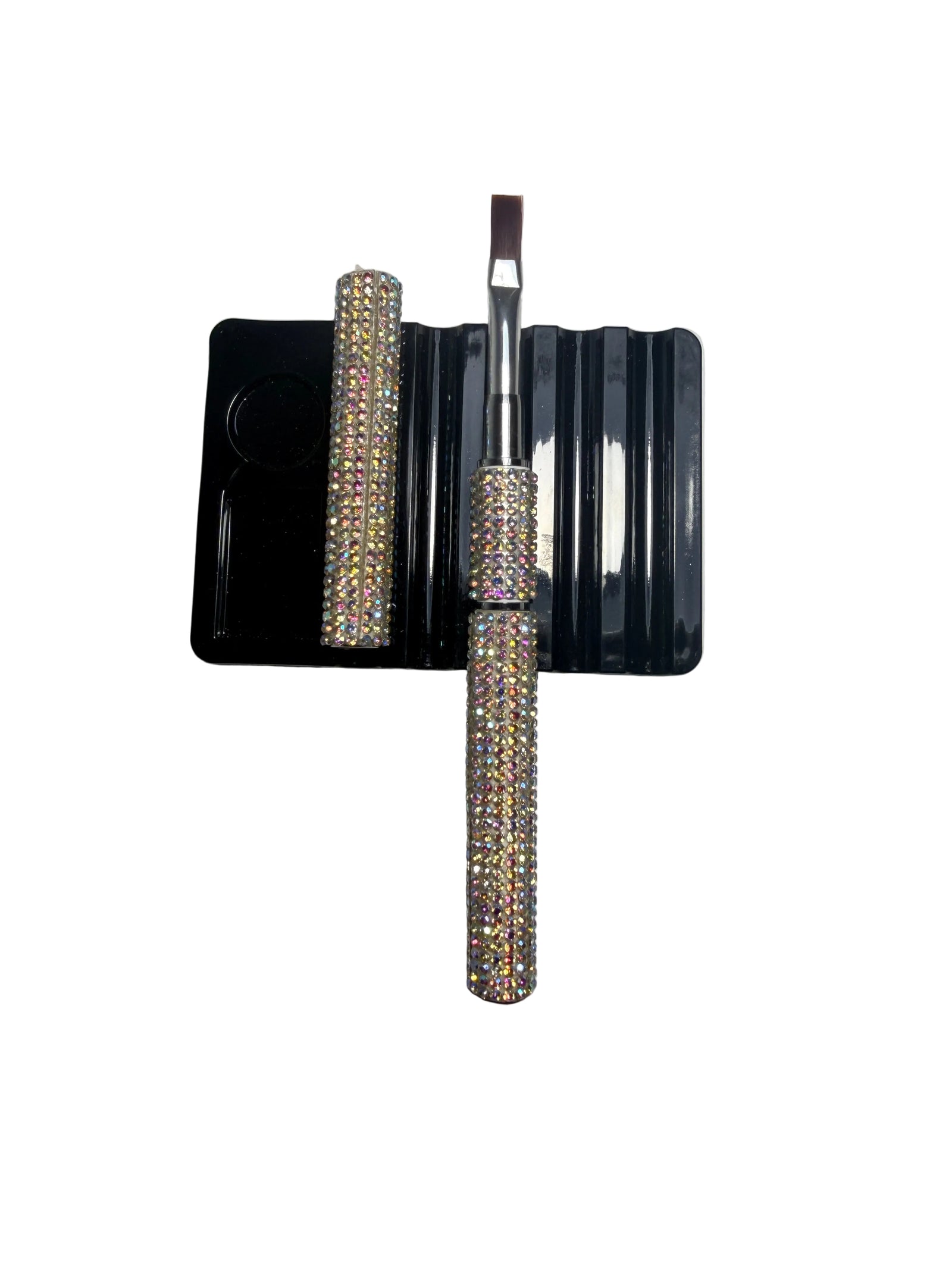 Builder gel brush with crystal handle on a gray background