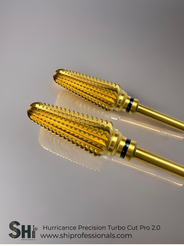 Two gold tungsten carbide nail drill bit with SHI branding on a gray background