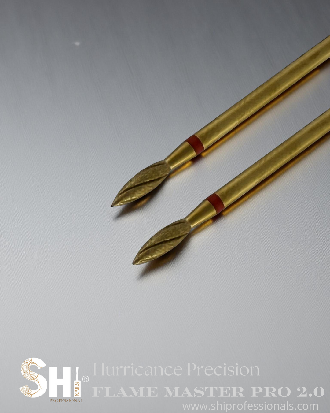 Two gold diamond flame bits pro 2.0 nail care tools with red bands on a gray background, featuring the SHi® Hurricane Precision logo.