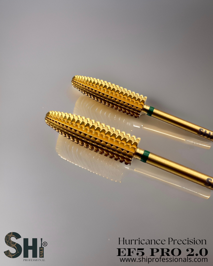 Two gold drill bits with SHI logo on a gray background