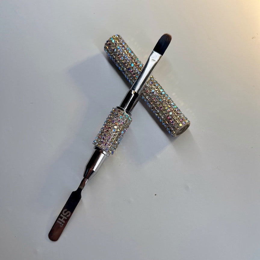 PolyGel brush with rhinestone handles on a white surface
