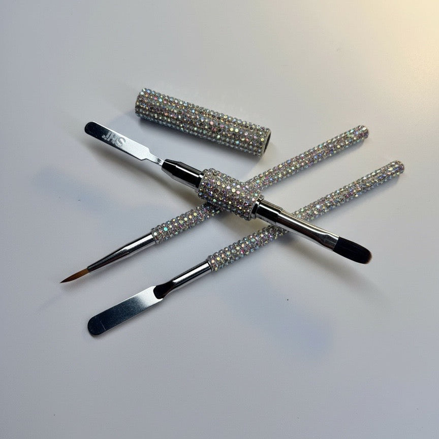 Set of gel brushes with crystal handles on a light gray background