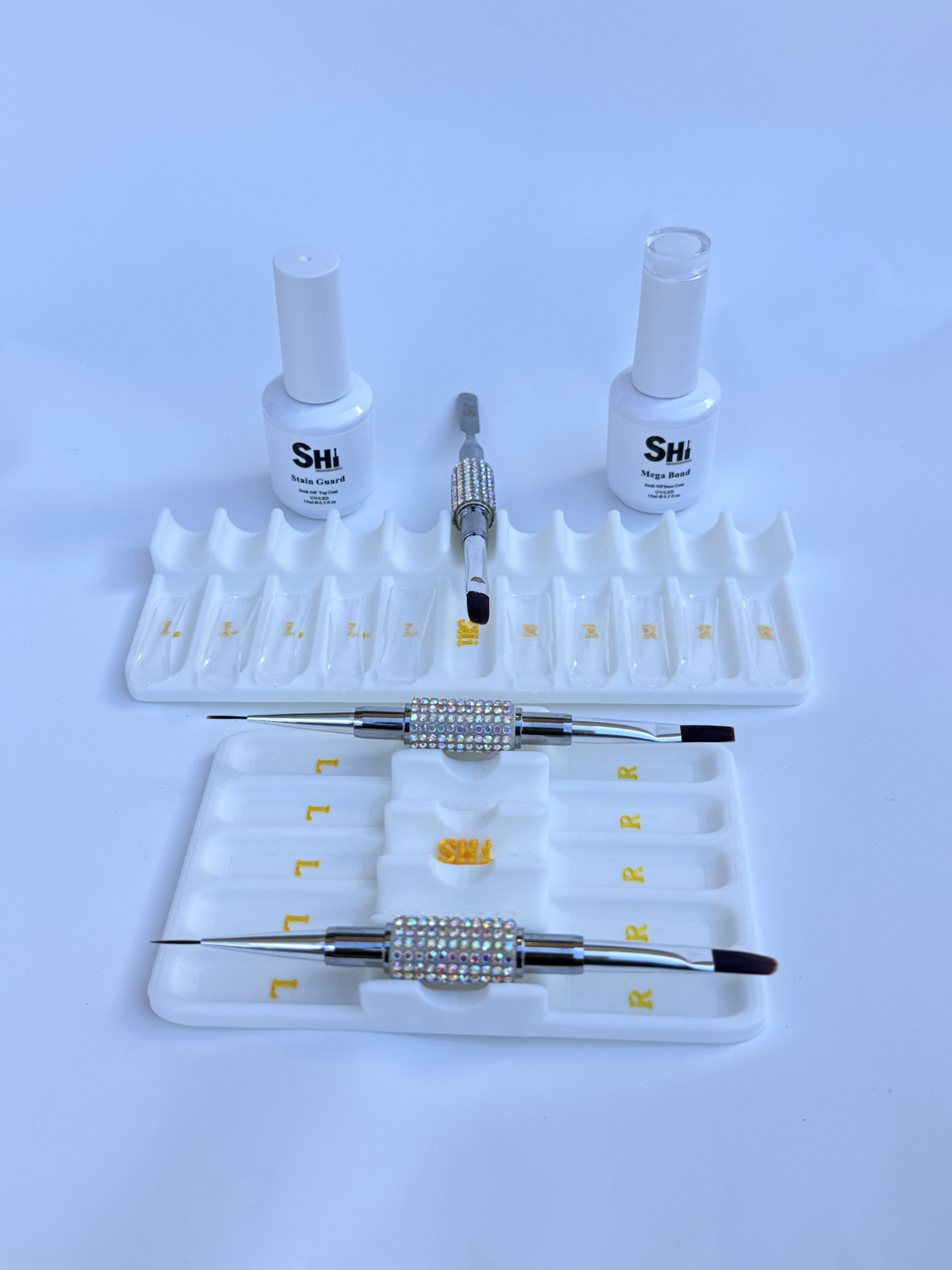 Nail art tool set with bottles and tools on a white background