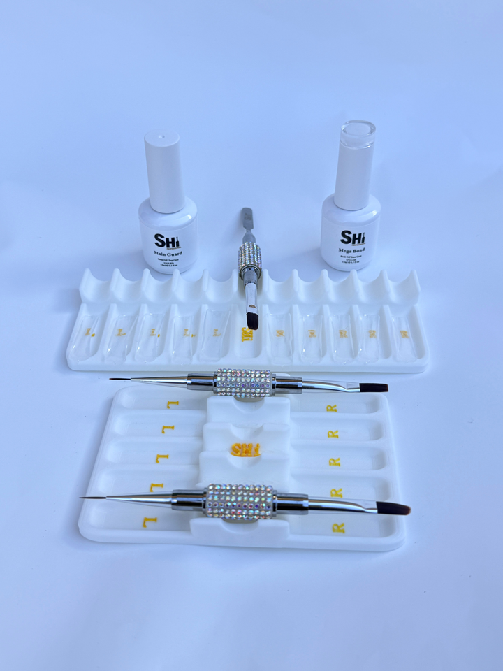 Nail art tool set with bottles and tools on a white background
