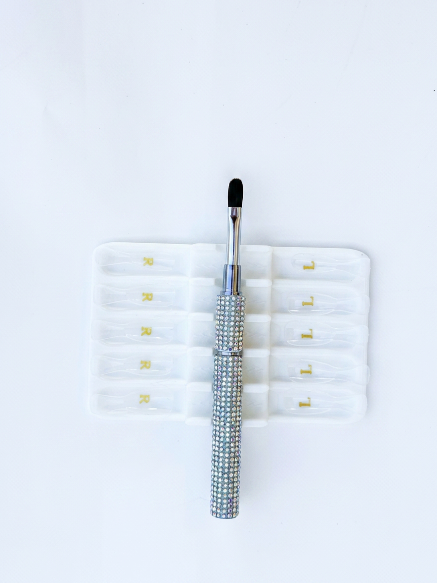 builder gel brush with black bristle tip on a white background