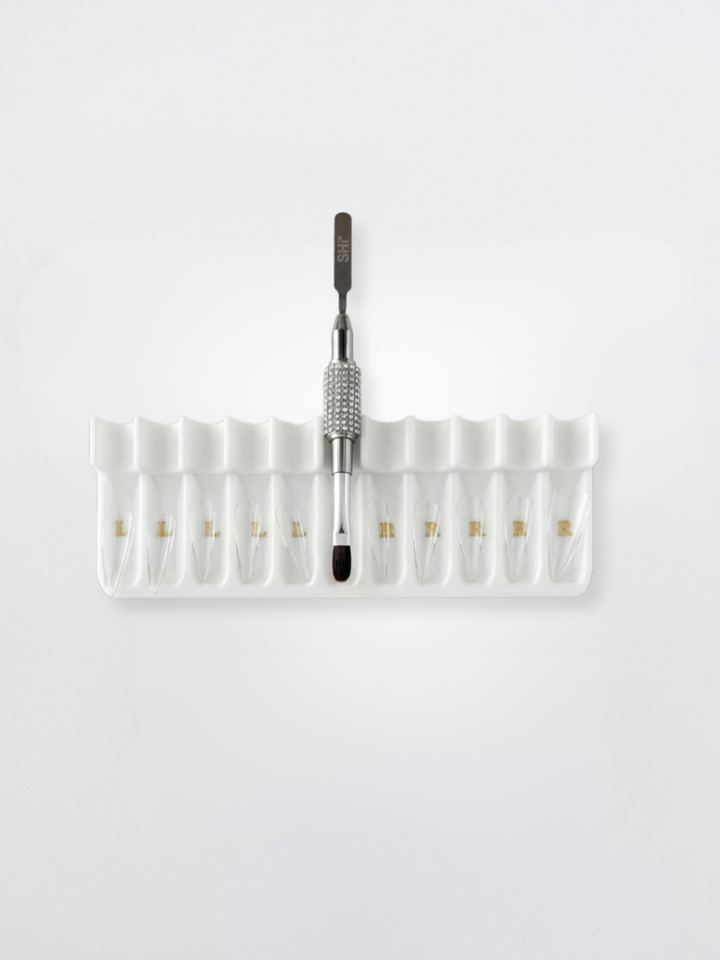 Set of clear soft gel tips, white tray, and bling brush with SHi brand logo on a white background